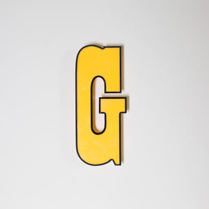 Yellow shop letter signage reclaimed
